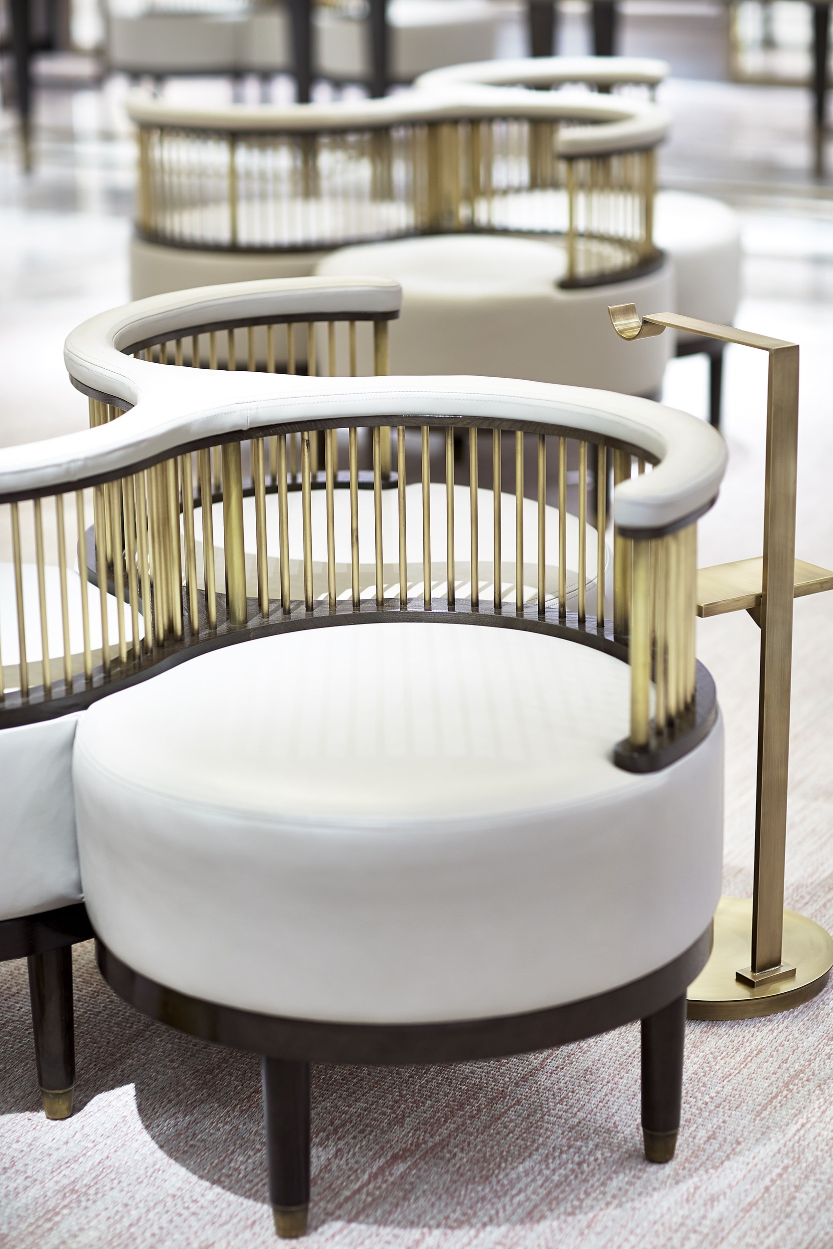 Stylish fresh white seating area with brass detail