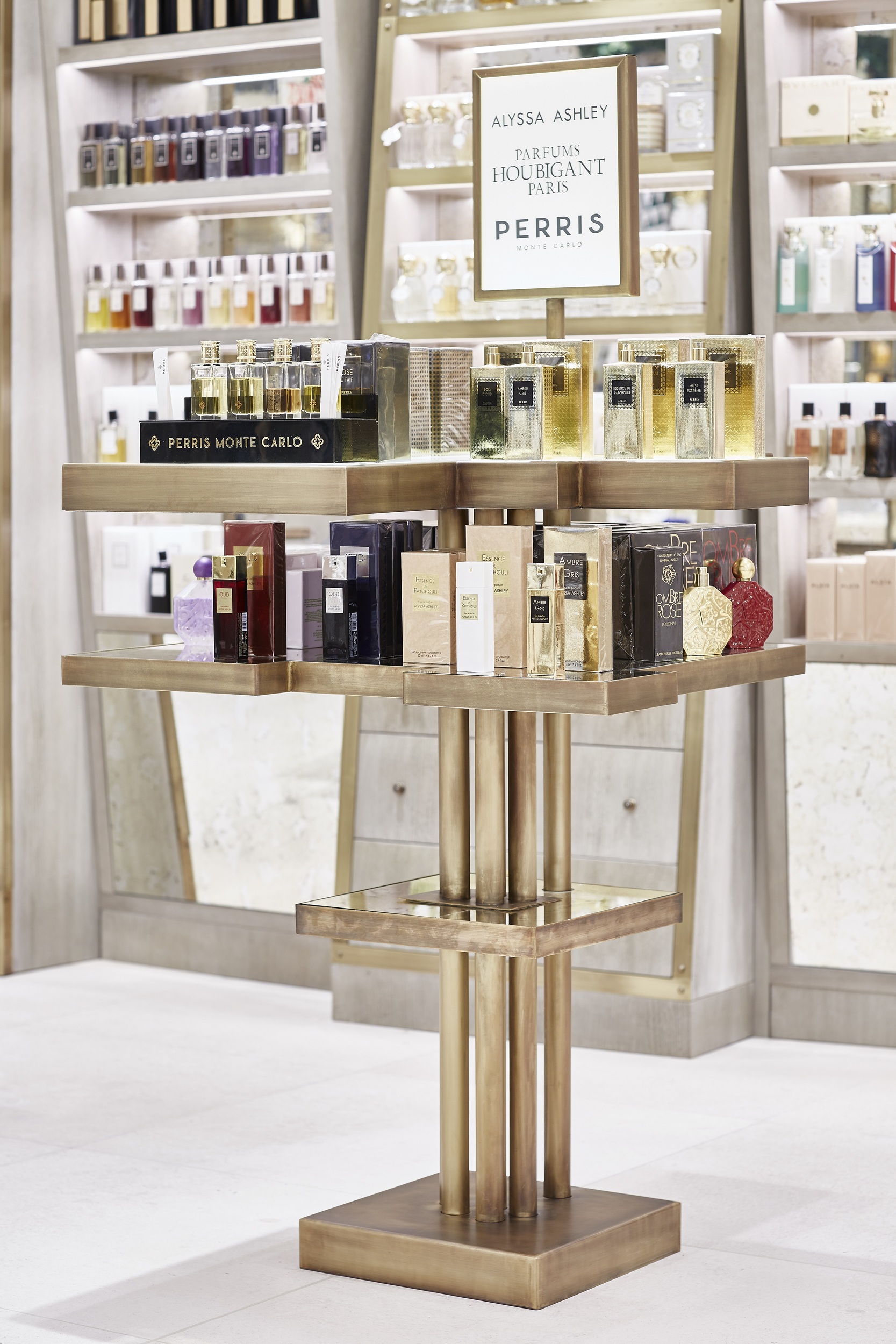 Elegant tiered perfume stand with brass shelving