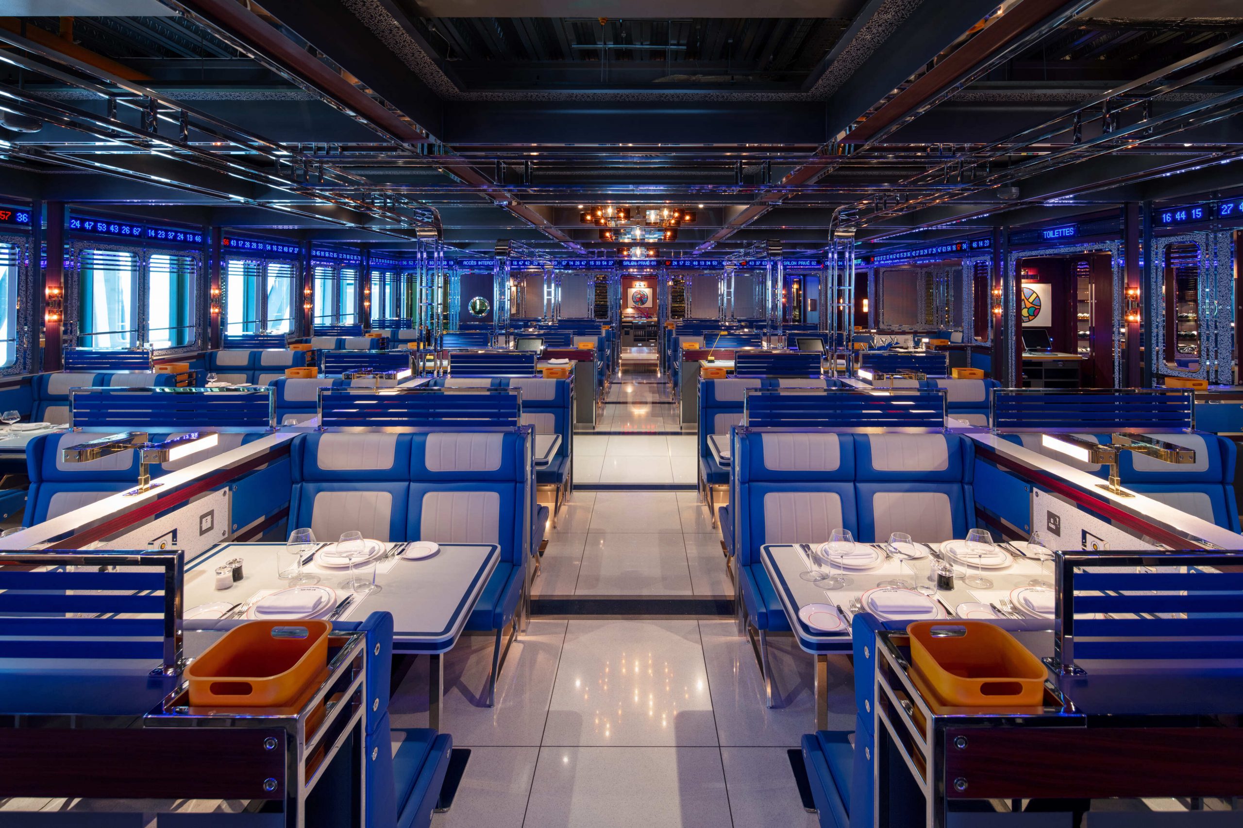 Wide angle yacht inspired blue diner booths with mirrored panel walls