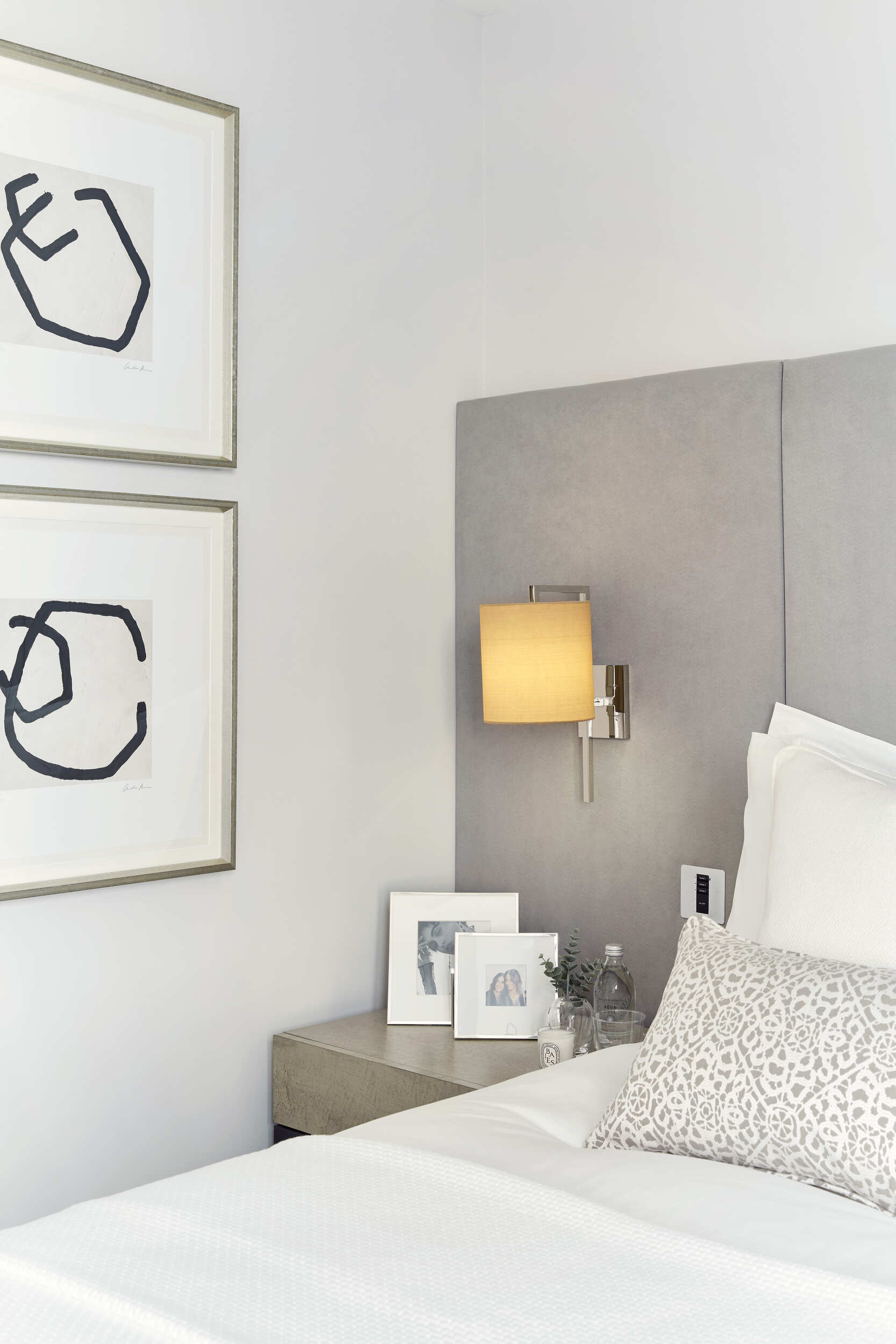 Bedroom features two wall hung minimalist art pieces