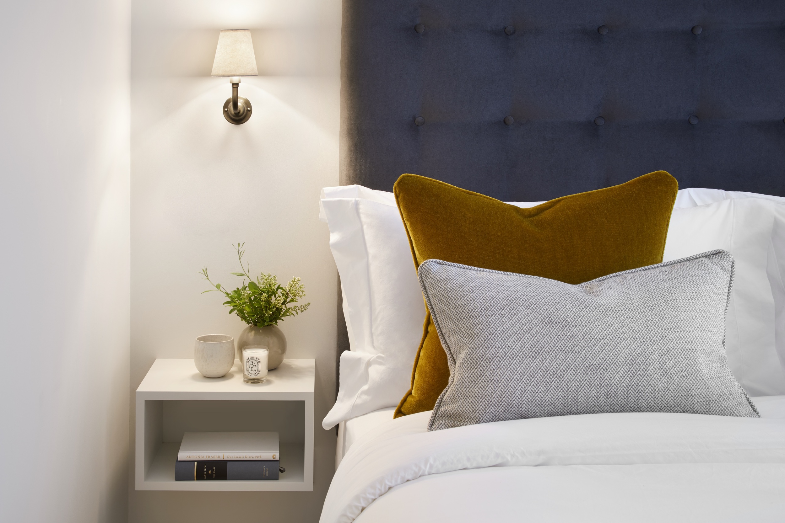 Contrasting cushions create welcoming bedroom