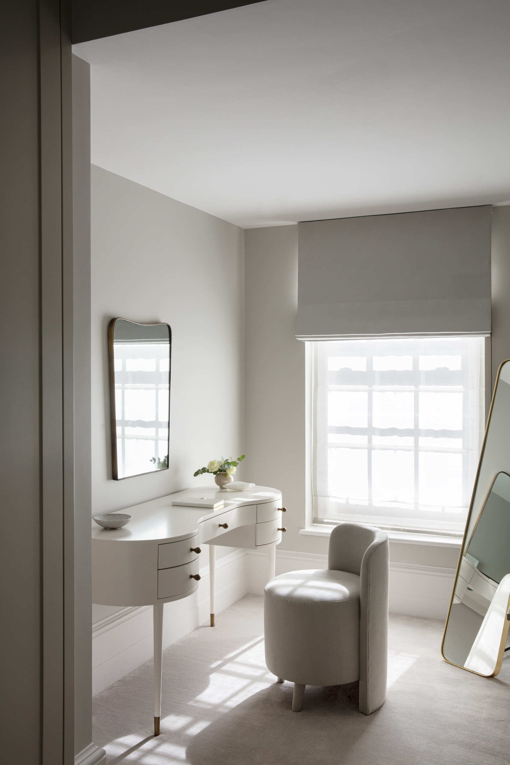 Dressing room with wall mounted mirror and freestanding