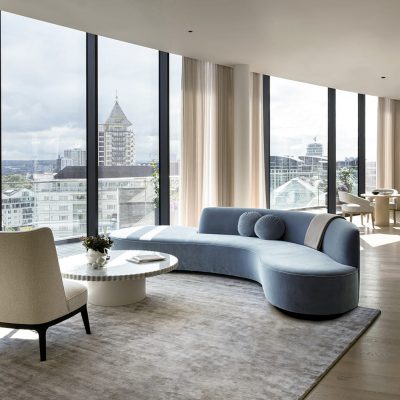 Living area with curved sofa and floor to ceiling windows
