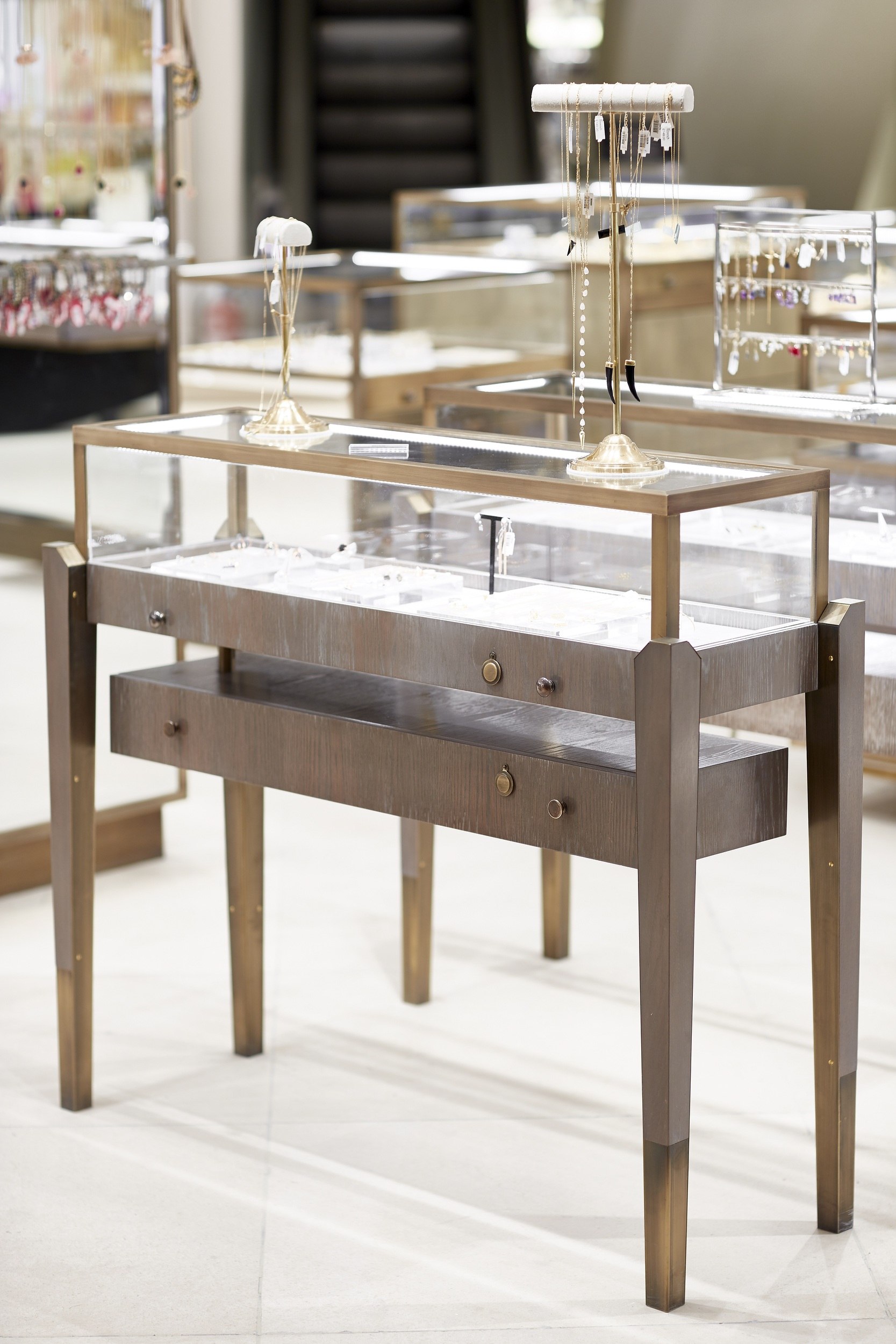 Elegant timber table display case with brass detail