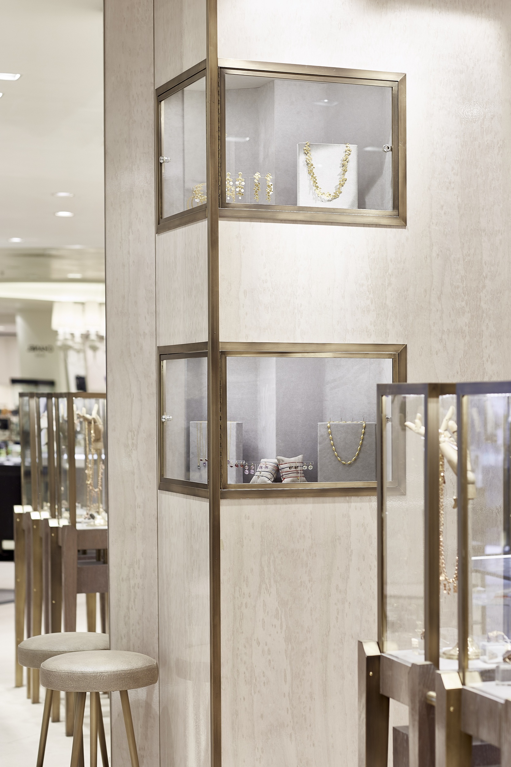 Wall display cases edged in brass and lined in custom linen