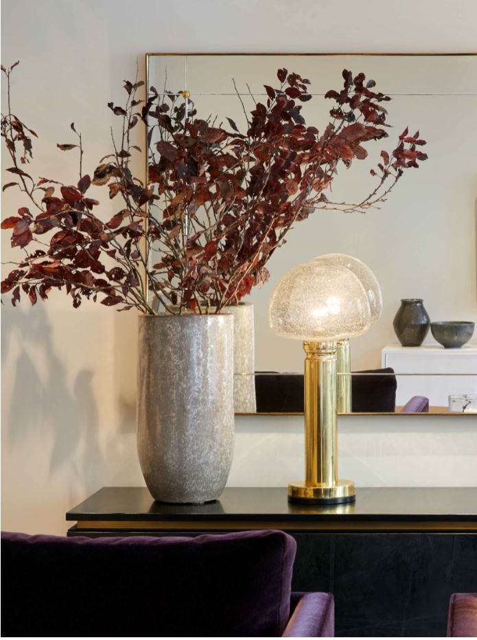 Plant and lamp on side table