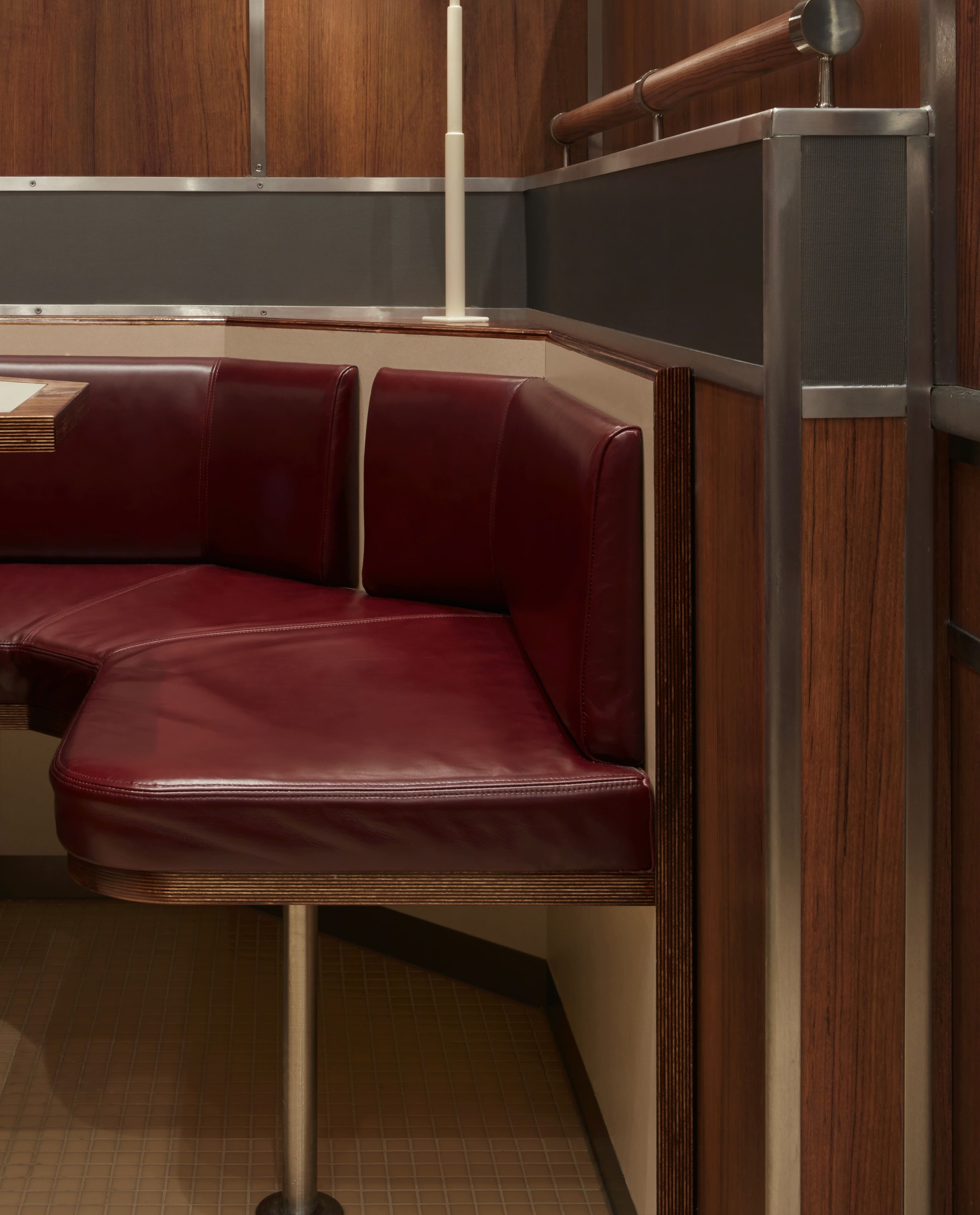 Close-up view of red leather café banquette