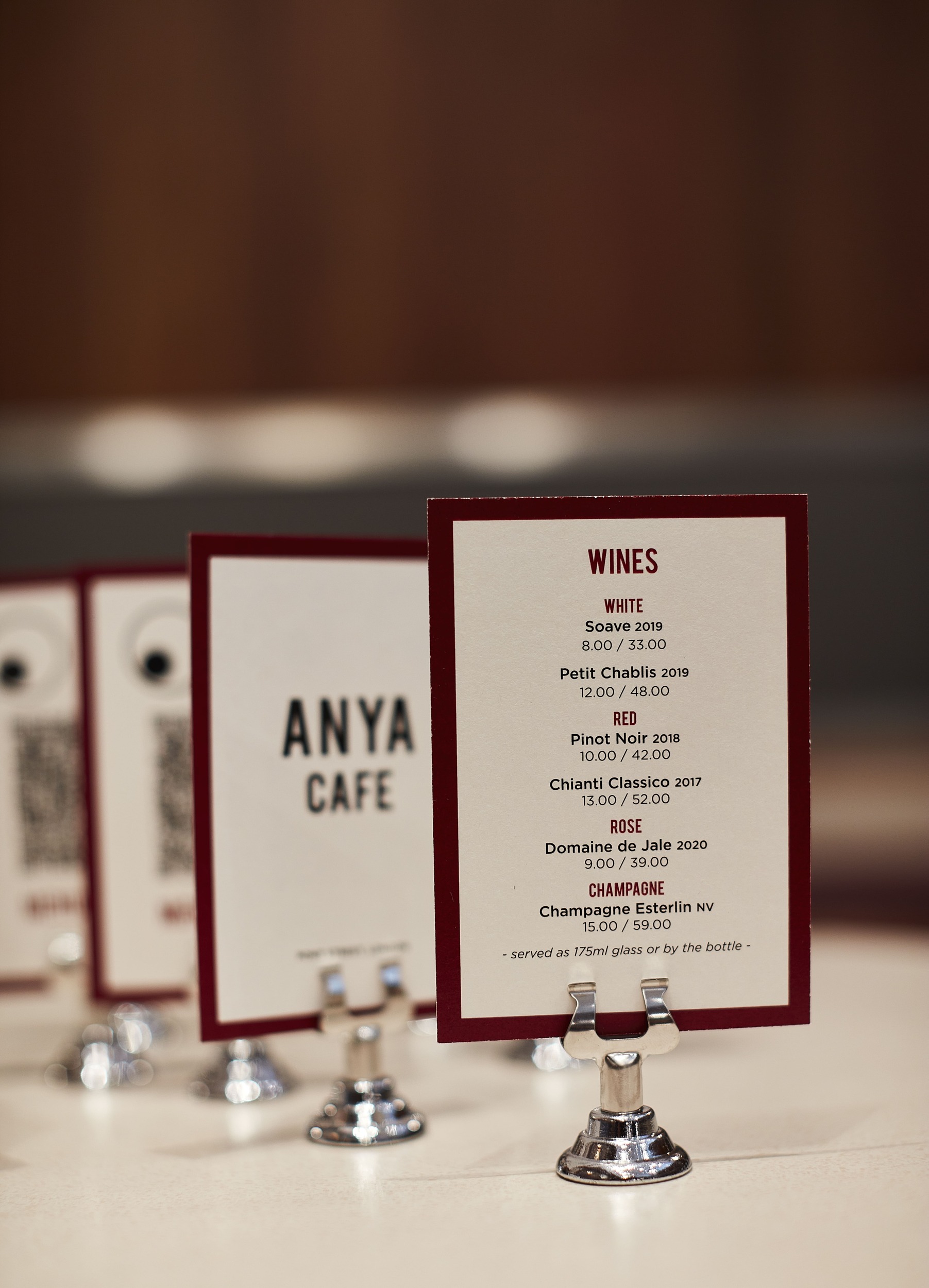 Row of wine menus on vintage table with classic silver menu stands