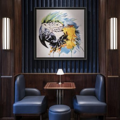 Colourful parrot art and private blue leather banquette