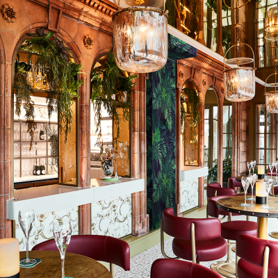 Harrods Perrier-Jouet Bar with red seats and background foliage
