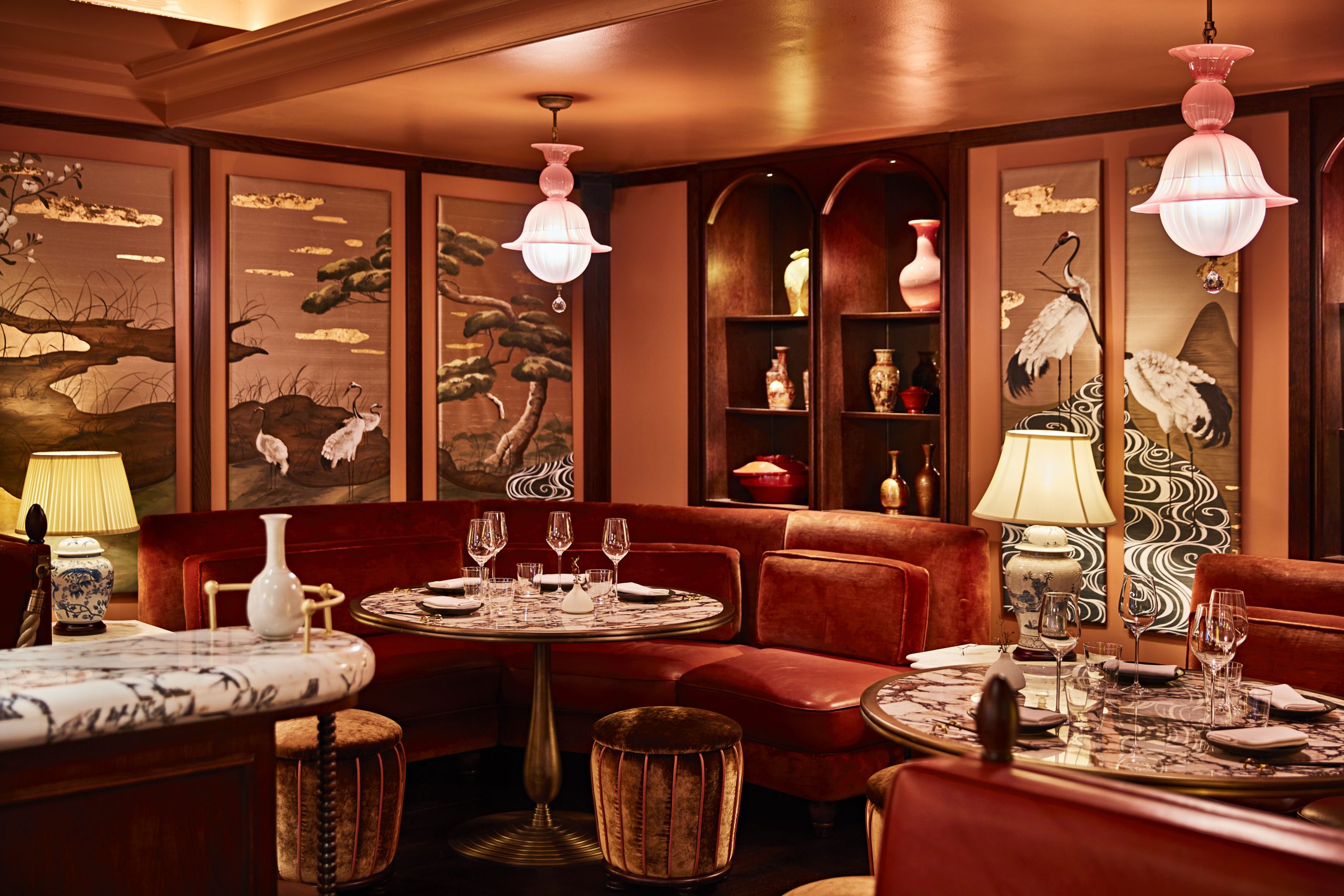 Luxurious Curio Lounge: Red velvet sofas, marble accents, opulent décor