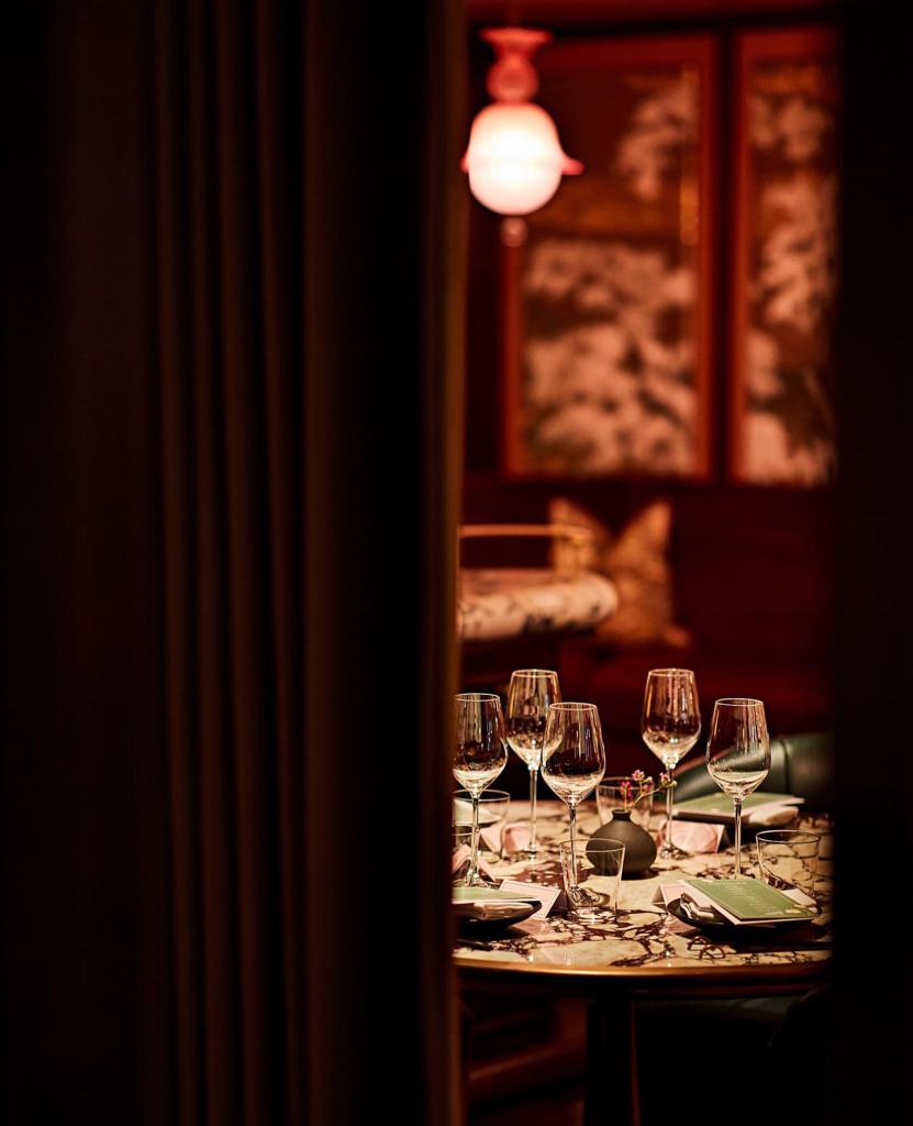 Table setting glimpsed through lavish drapery