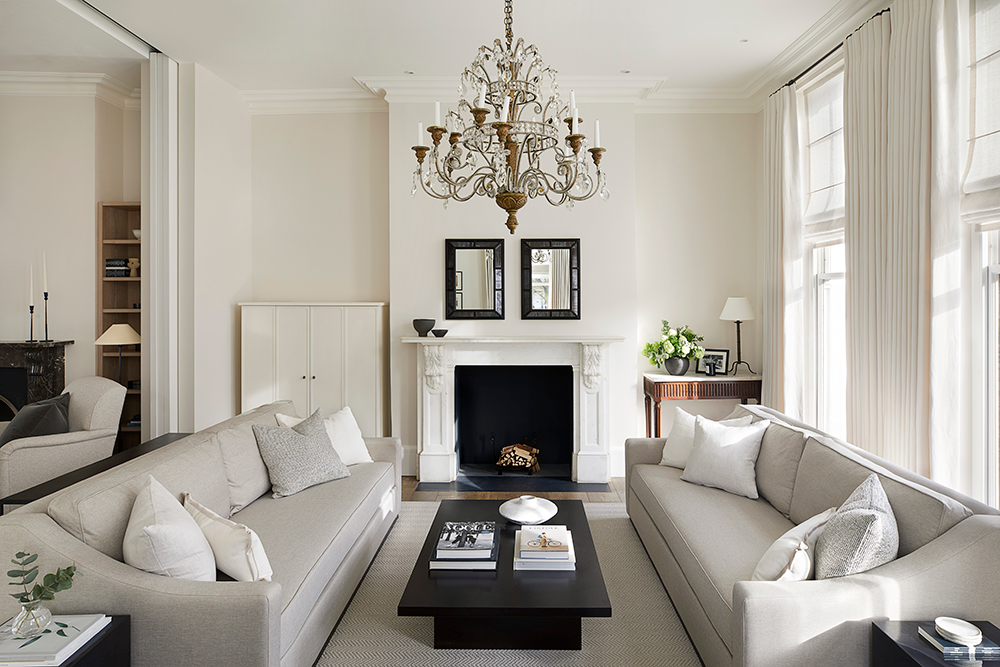 A neutral drawing room layered with creams mixing contemporary furniture with antique pieces.